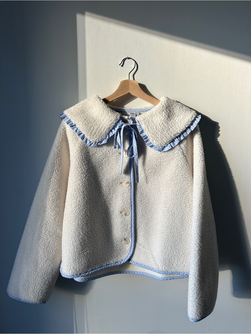 Simons Cream Sherpa Jacket with Light Blue Trim and Ribbon Tie